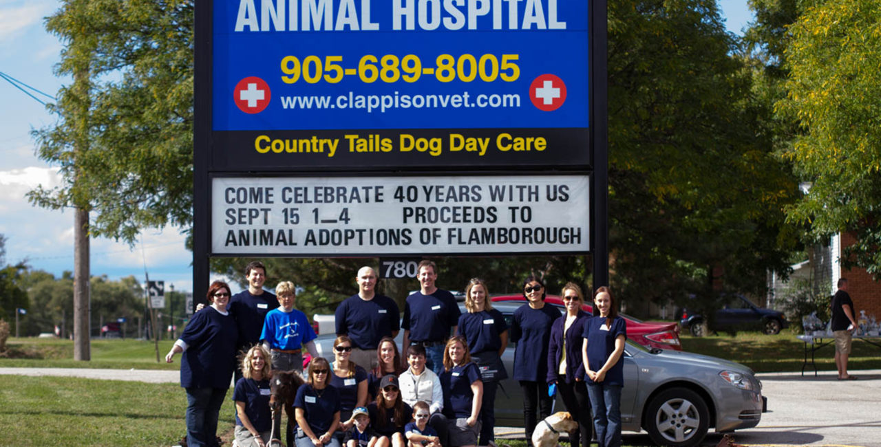 Staff in front of Clappison Animal Hospital sign
